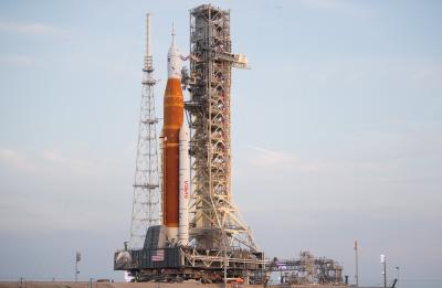 La fusée Space Launch System (SLS) de la NASA, avec l’engin spatial Orion à son bord, apparaît au sommet du lanceur mobile alors qu’elle remonte la rampe de la plateforme de lancement 39B, le 17 août 2022, au centre spatial Kennedy de la NASA en Floride.
