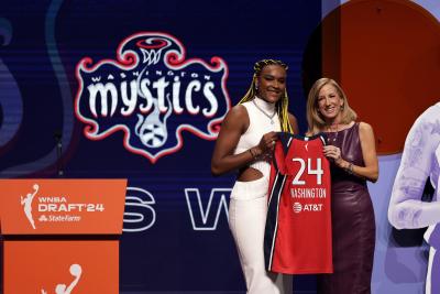 Aaliyah Edwards reçoit un chandail des Washington Mystics après avoir été choisie par l’équipe lors du repêchage de basketball de la WNBA. (Photo AP/Adam Hunger)